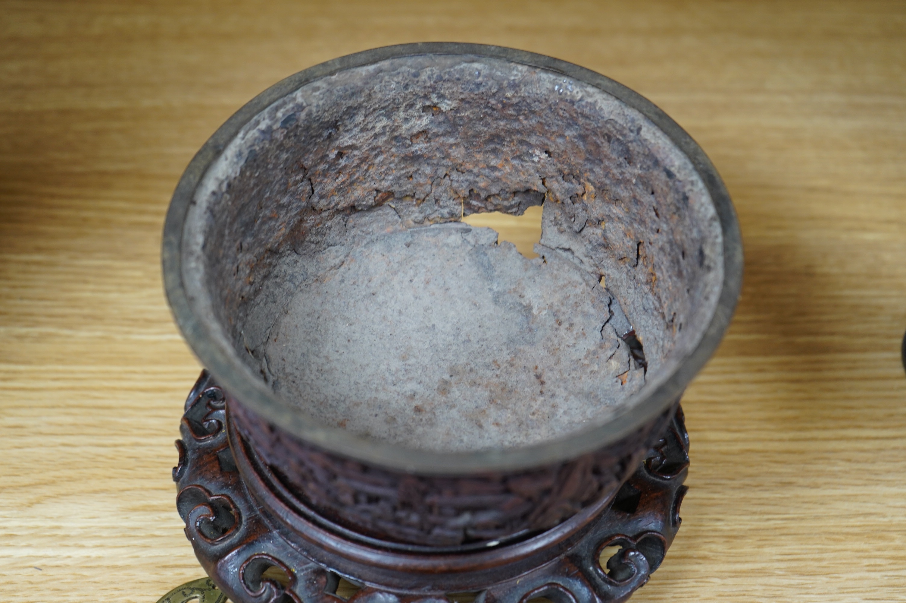 An 18th/19th century Chinese cinnabar lacquer bowl, on carved hongmu stand and a Chinese pierced brass disc. Condition - poor